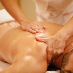 relaxed man enjoying in back massage at health spa.